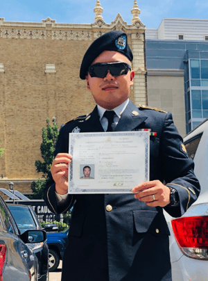 Army SPC Ge receives his certificate of naturalization after successful litigation filed by immigration attorney David Gluckman